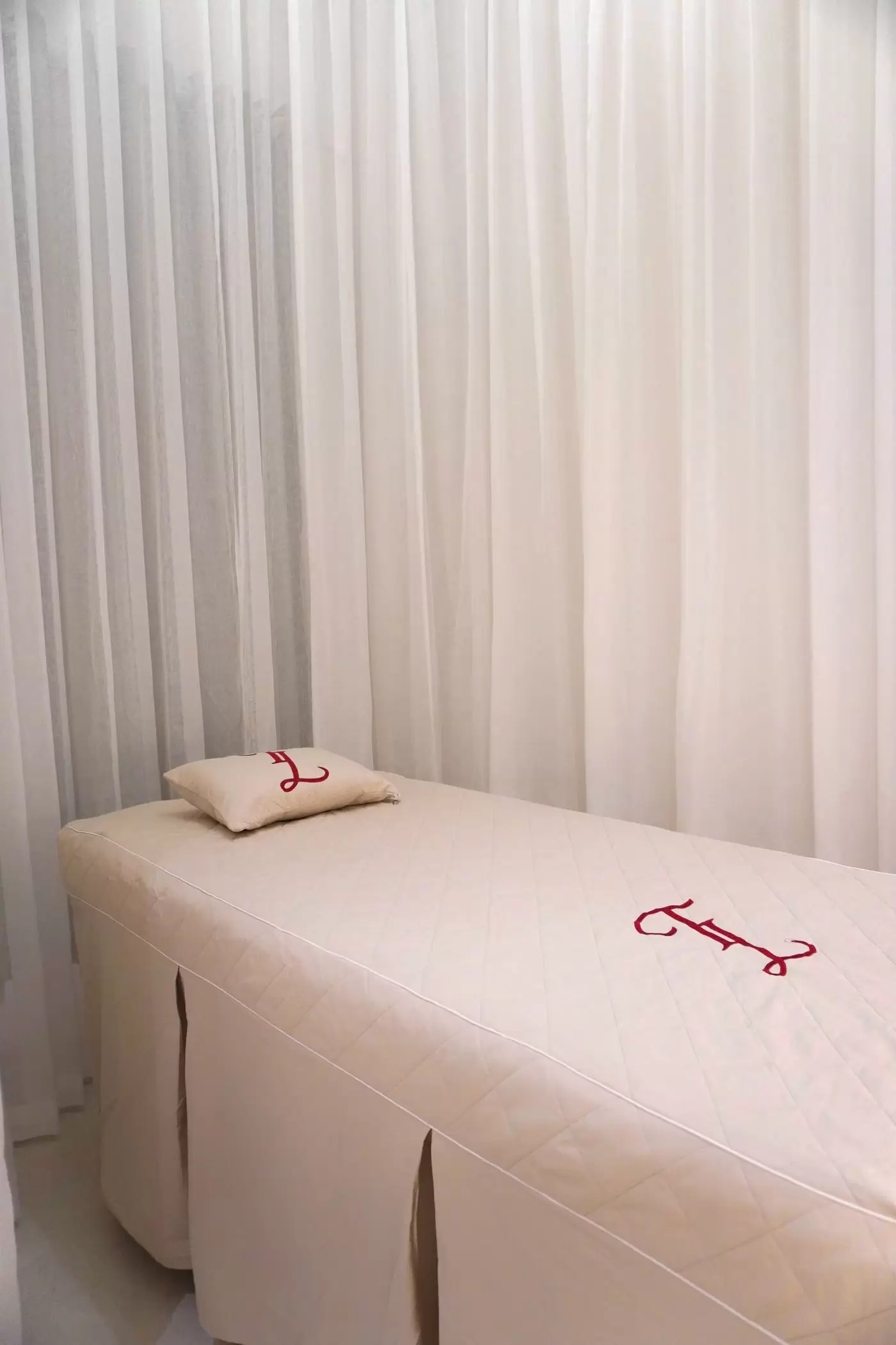 Massage table with white drapes in a premium spa